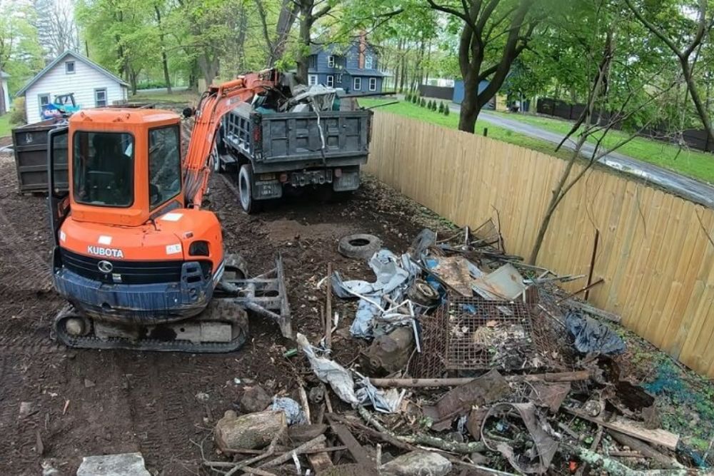 A parked dump truck adjacent to a debris pile, showcasing a demolition and junk removal service in Seattle, WA.
